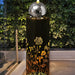 Botanical Twilight Bubbler Water Feature illuminates in the evening