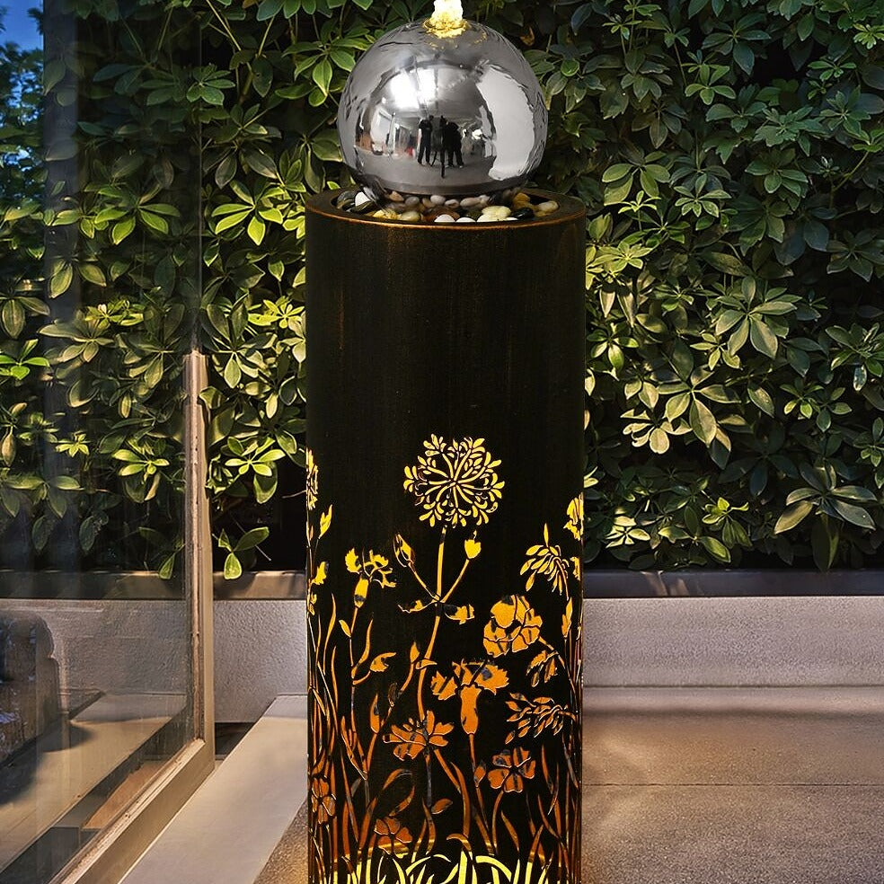 Botanical Twilight Bubbler Water Feature illuminates in the evening