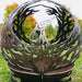 Corten Phoenix Sphere Fire Pit Bowl in the garden