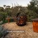 Corten Steel Fire Bowl – The Phoenix with tree background