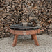Grill with pile of wood background