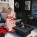 Lady sits next tenderflame Aria Fire Pit