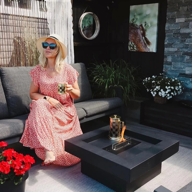 Lady sits next tenderflame Aria Fire Pit