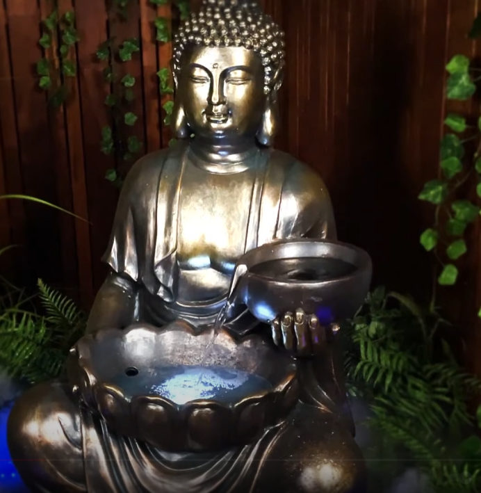 Tranquil sitting Buddha with bowl water feature fountain slight right angle view