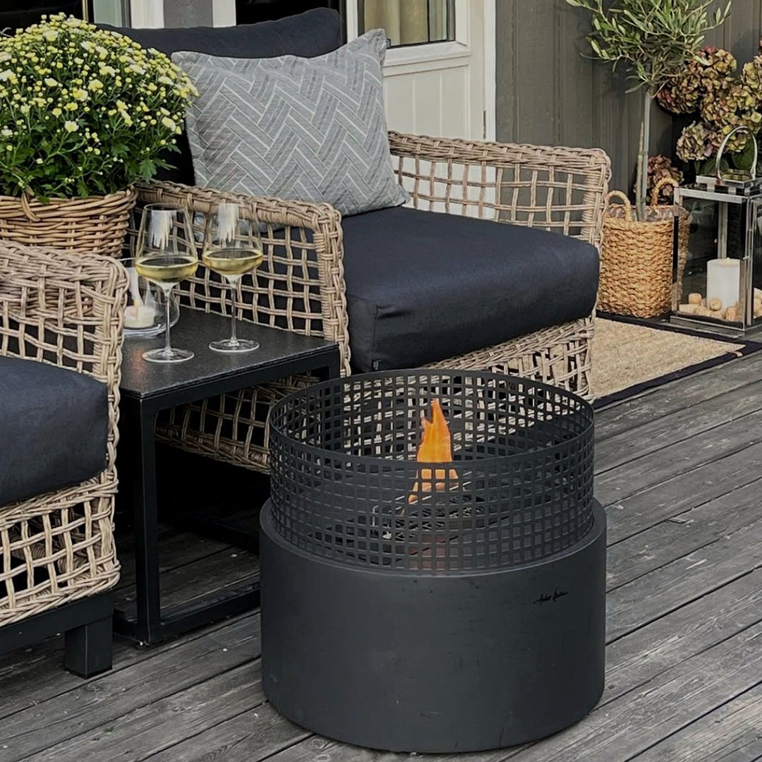 Two wine glasses and a tenderflame fireplace outside