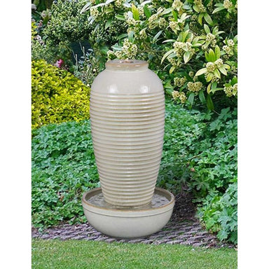 Unda Urn Bubbling Water Feature in the garden
