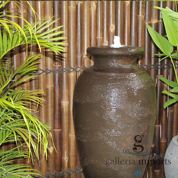Urn Amphora fountain with bamboo fence