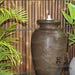 Urn Amphora fountain with bamboo fence