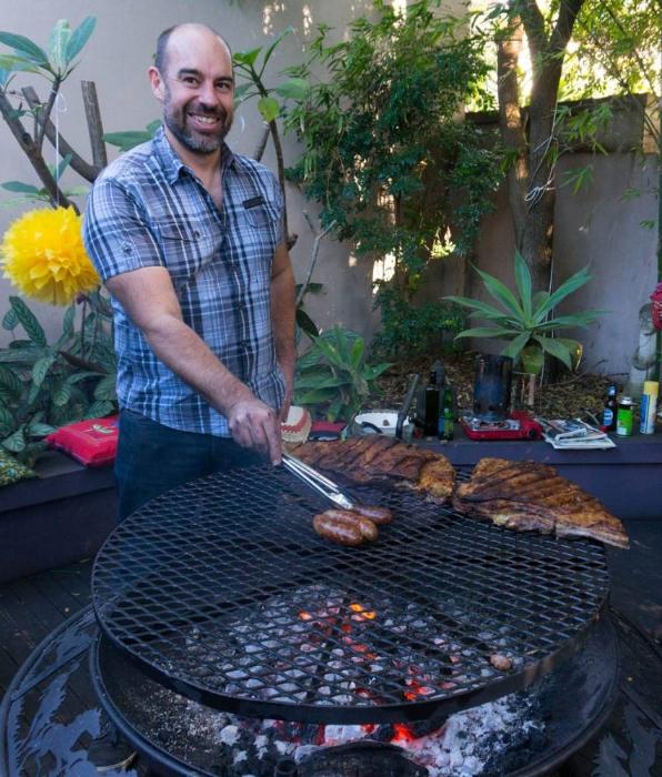 man enjoys cooking bbq