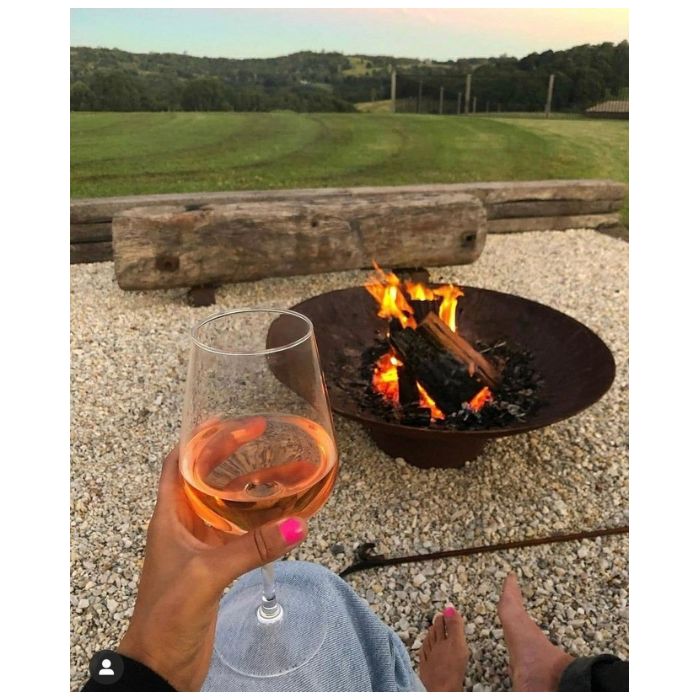 one glass of wine and fire pit