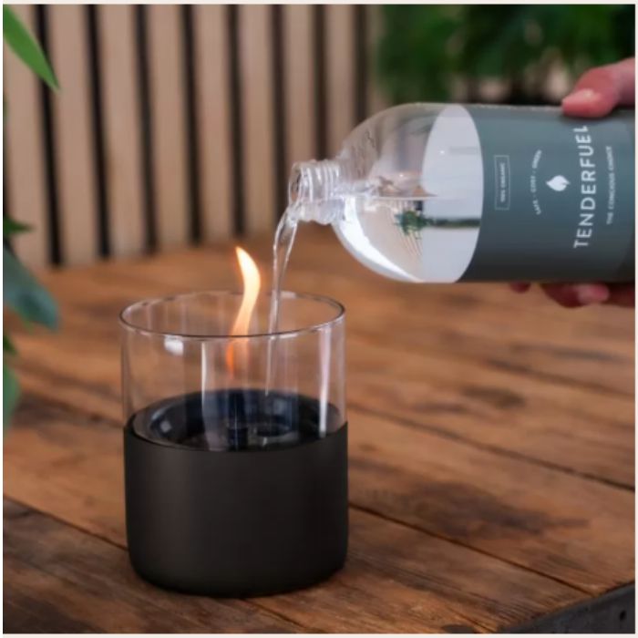 pouring fuel into a small fire glass